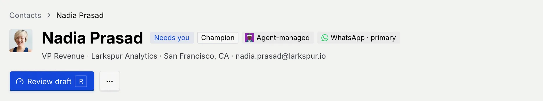 The record header for Nadia Prasad: the Contacts breadcrumb, her photo, the badges Needs you, Champion, Agent-managed and WhatsApp · primary, the line VP Revenue · Larkspur Analytics · San Francisco, CA · nadia.prasad@larkspur.io, and the Review draft button