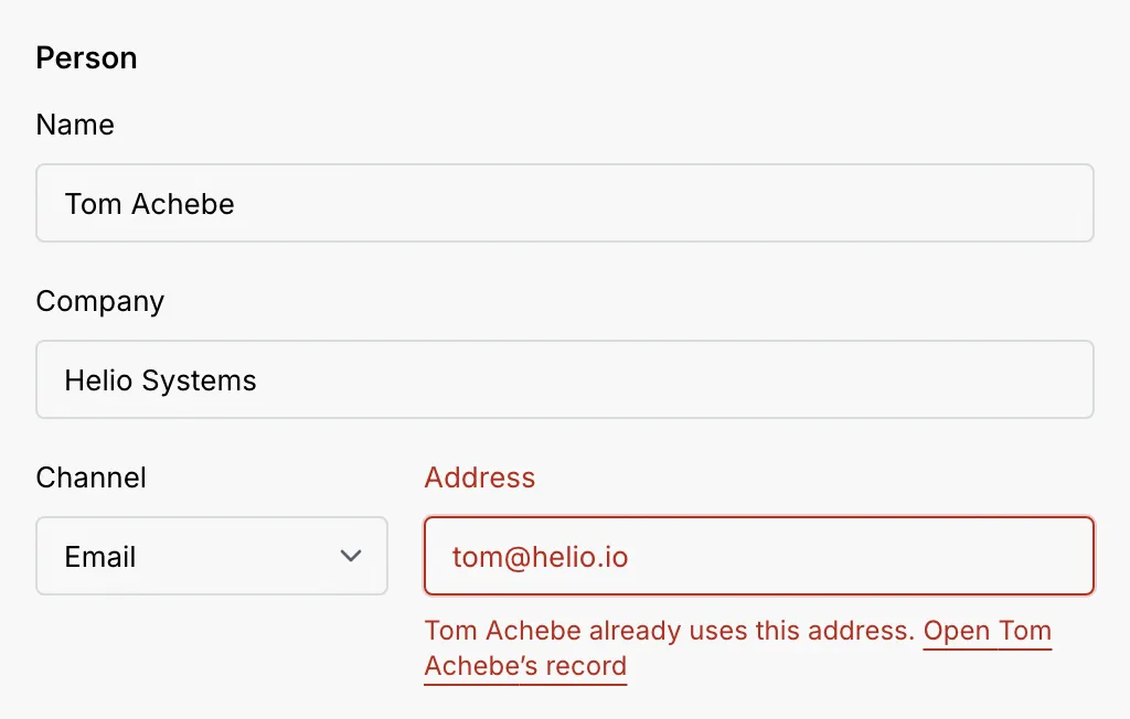 The Person section with Email tom@helio.io and the error Tom Achebe already uses this address, with a link to open Tom Achebe's record